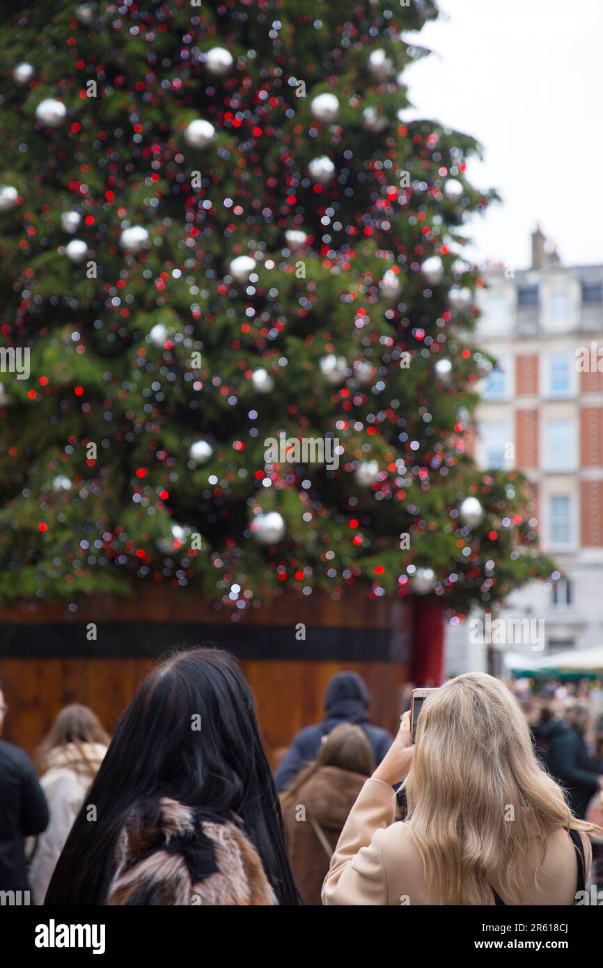 Christmassy decorations and artificial snow flakes are seen in Covent