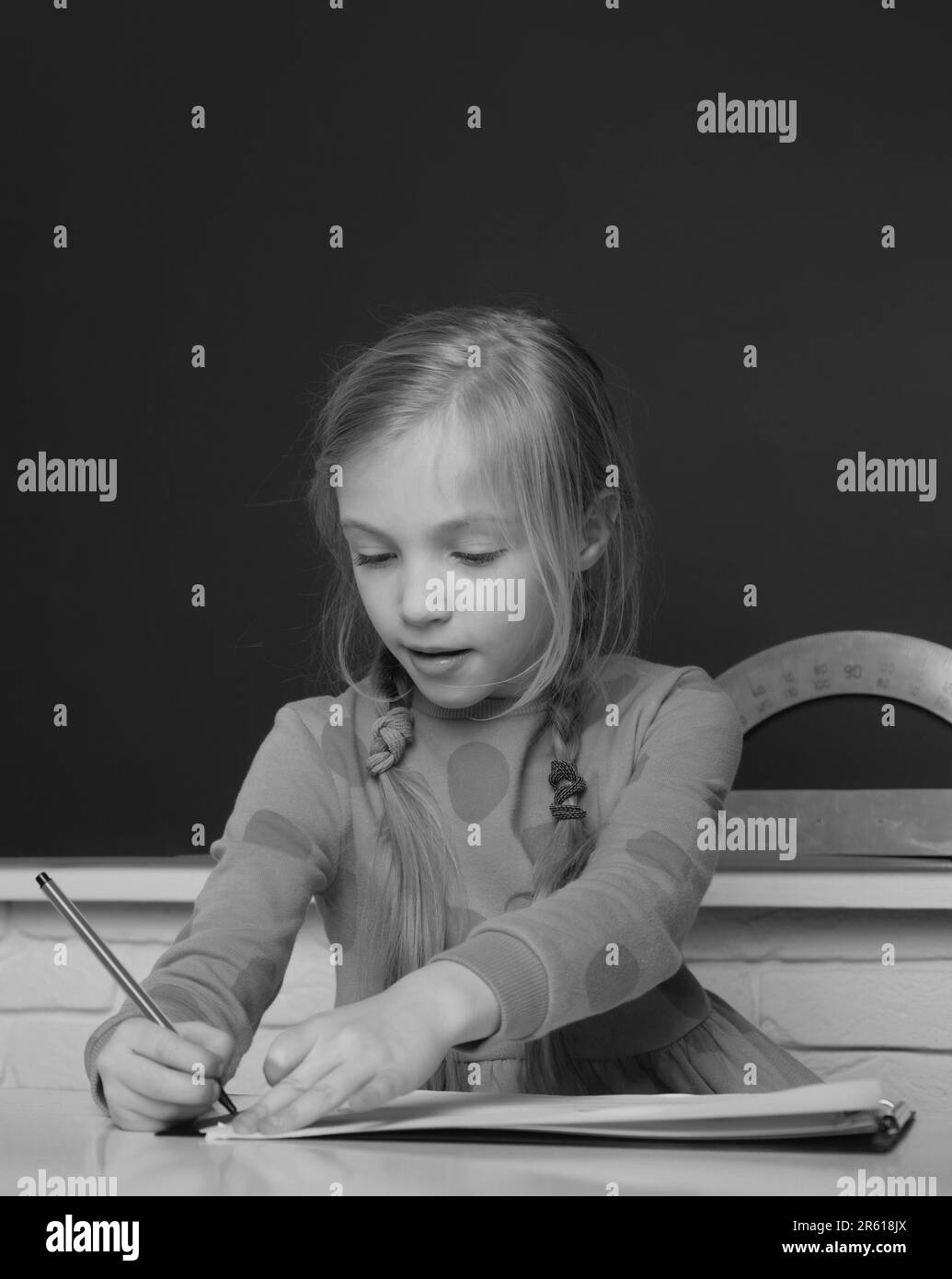 School concept. Kids drawing in notepad. Little girl pupil study in