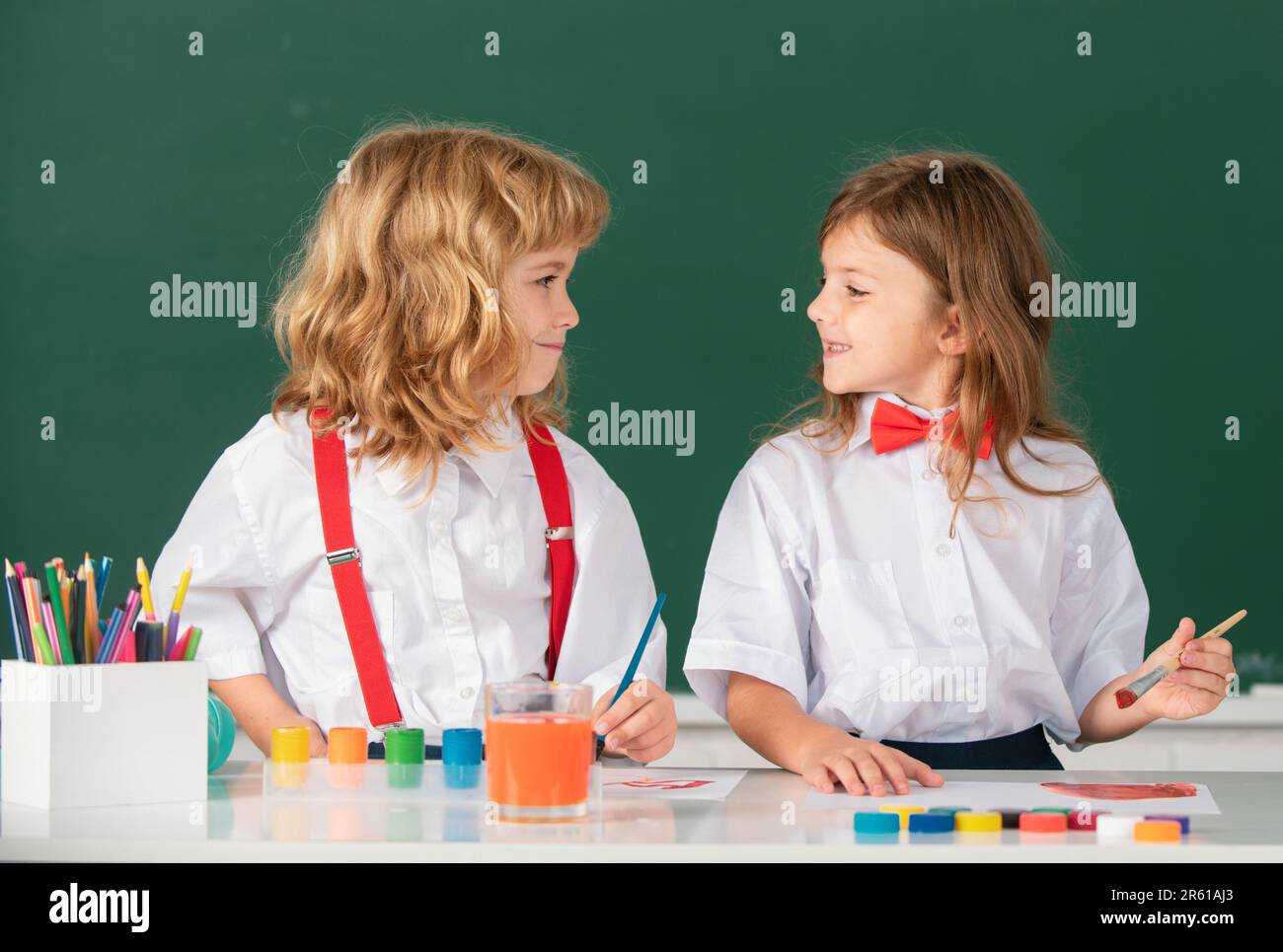 Funny pupils draws in classroom on school blackboard background. School ...