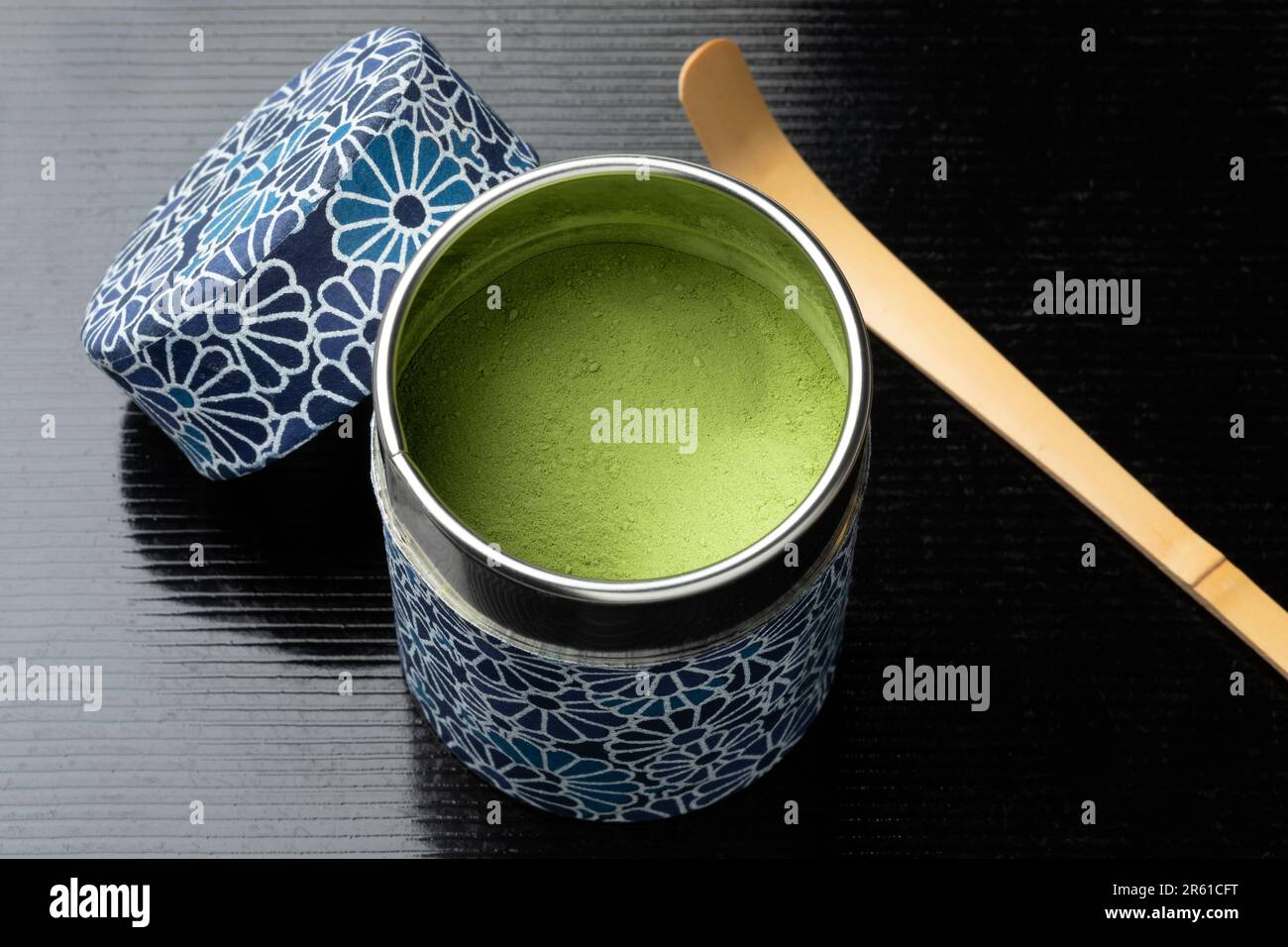Traditional Japanese tea tin with matcha tea close up and a bamboo Chashaku Stock Photo
