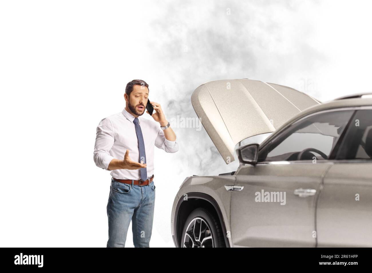 Man with a car problem calling a road help company isolated on white