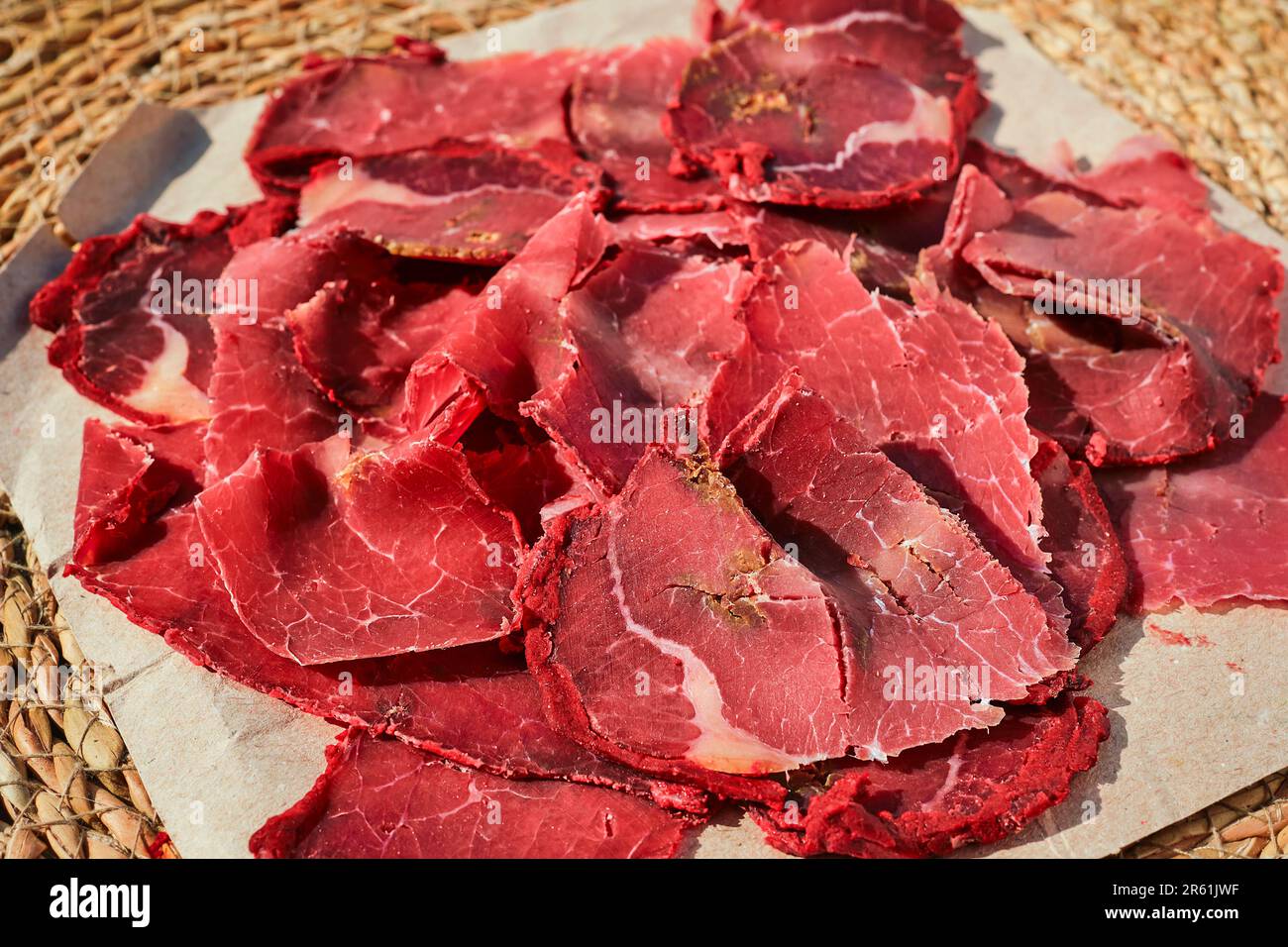 Dried meat, bacon, or Turkish pastirma close-up, selective focus on meat traditional dish, traditional Turkish food Stock Photo