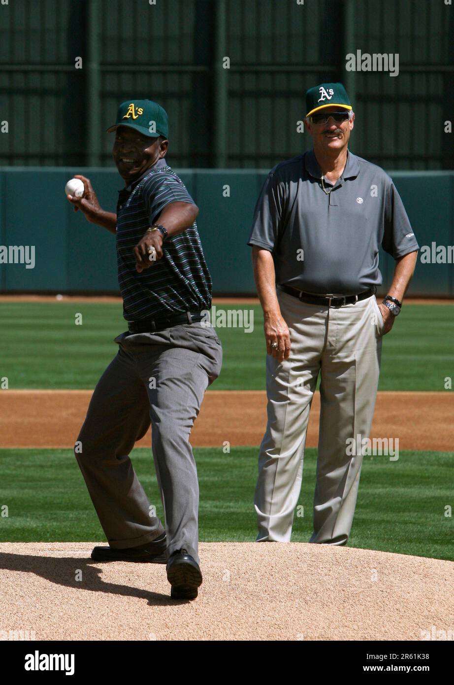 Rollie Fingers (right) watches John Blue Moon Odom toss the first pitch  before the Oakland A's 6-5 win over the Chicago Cubs in a spring training  baseball game at Phoenix Municipal Stadium