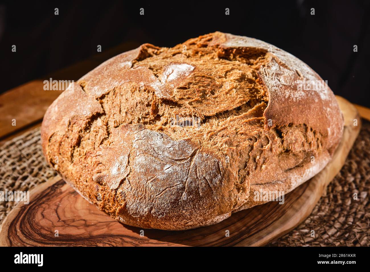 Freshly baked artisan rye bread on the table, close-up, selective focus. Homemade bread with whole wheat flour. Products from the farm Stock Photo