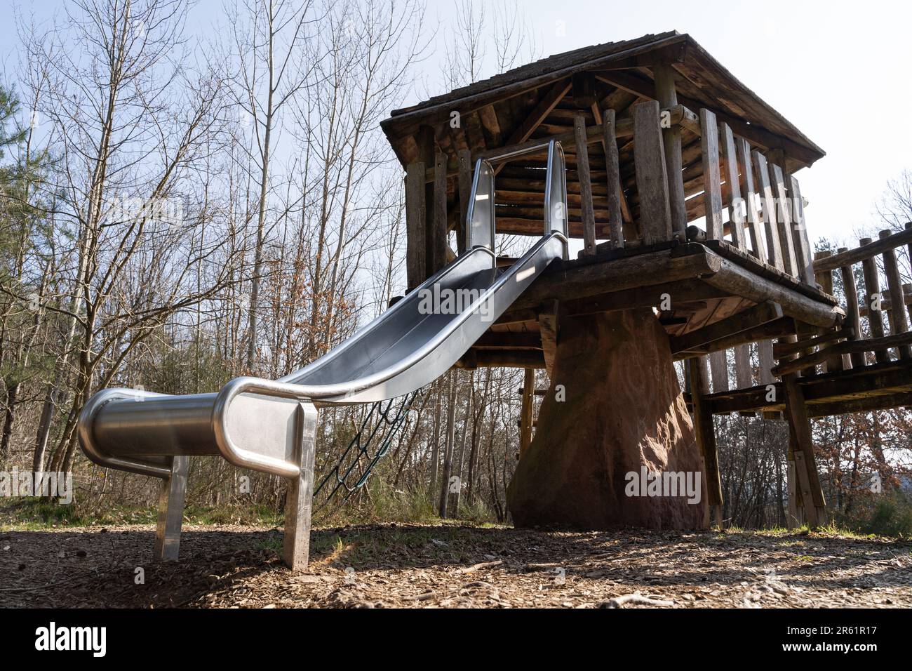 Wooden play house with a slide for children in the playground Stock Photo