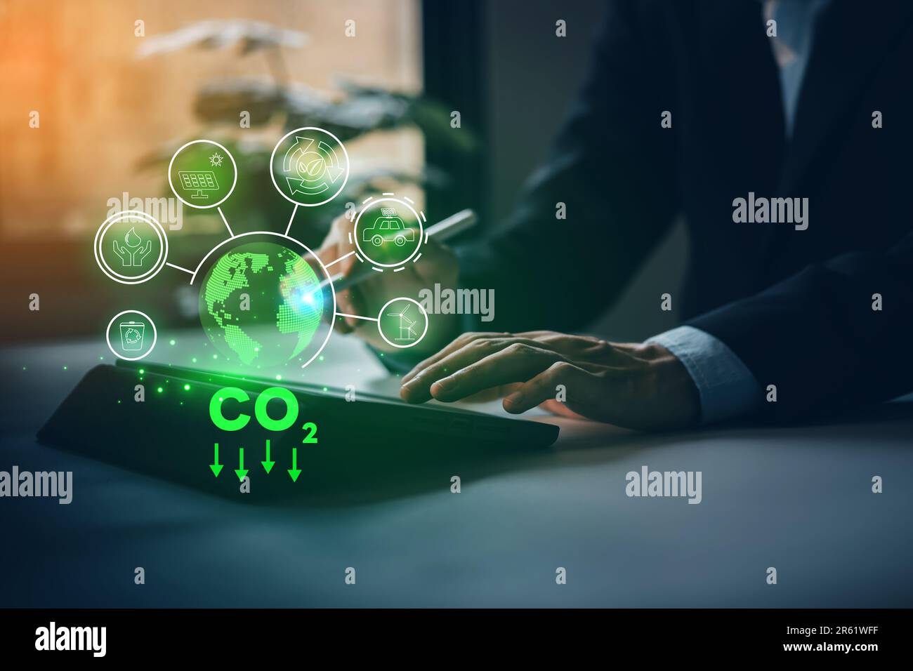 CO2 emission concept. ESG, Environmental, social, and governance in sustainable and ethical business. Businessman hand typing taplet with global envir Stock Photo