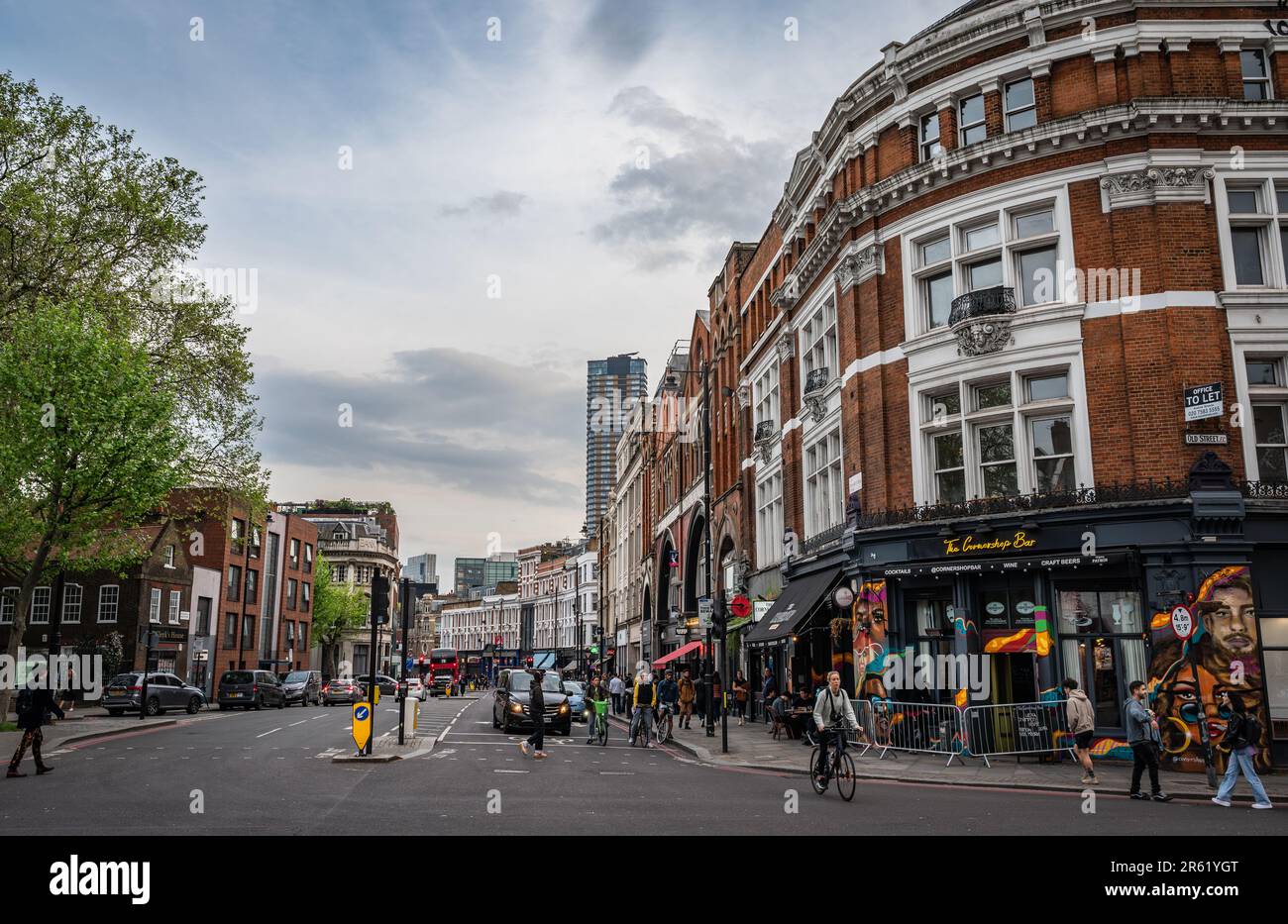 London, UK: Looking south along Shoreditch High Street in London with restaurants, bars and shops. Junction with Old Street. Stock Photo
