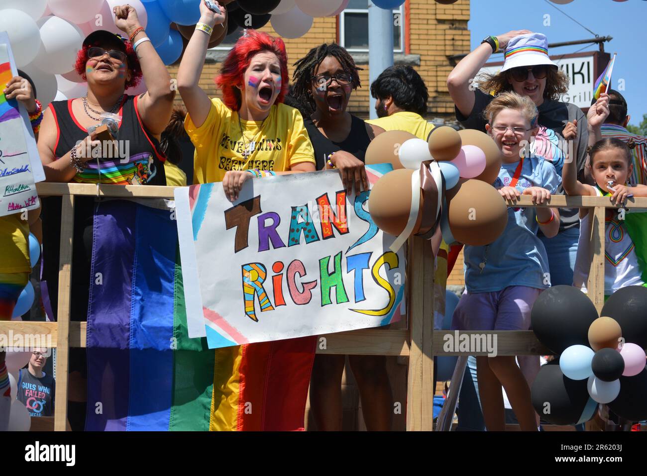 Young people holding a 'Trans Rights' sign on a float in the annual Buffalo Pride Parade. Stock Photo