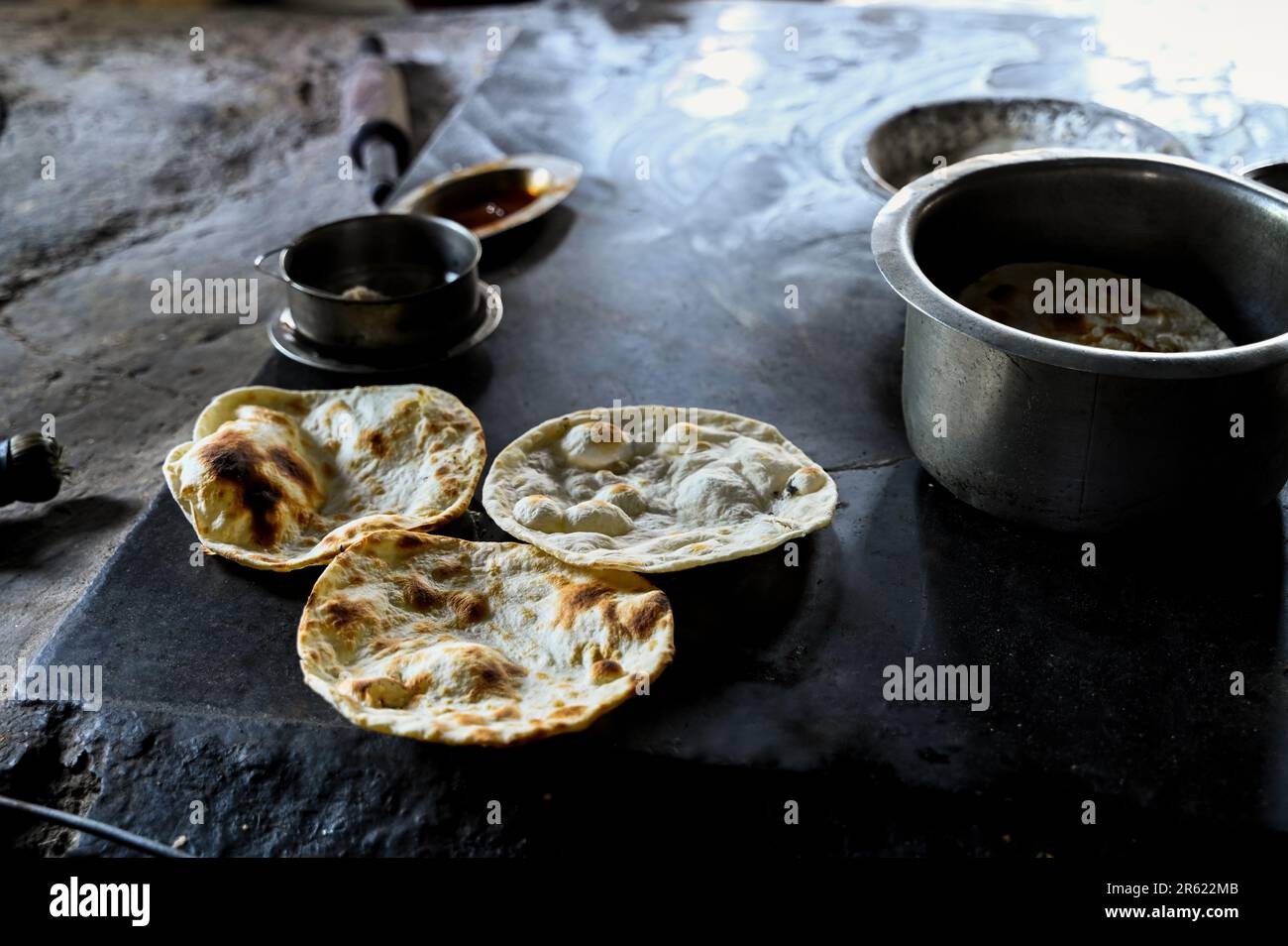 Three Tandoor roti freshly made to serve in the punjabi dhaba with utensils near it. Selective focus. Stock Photo