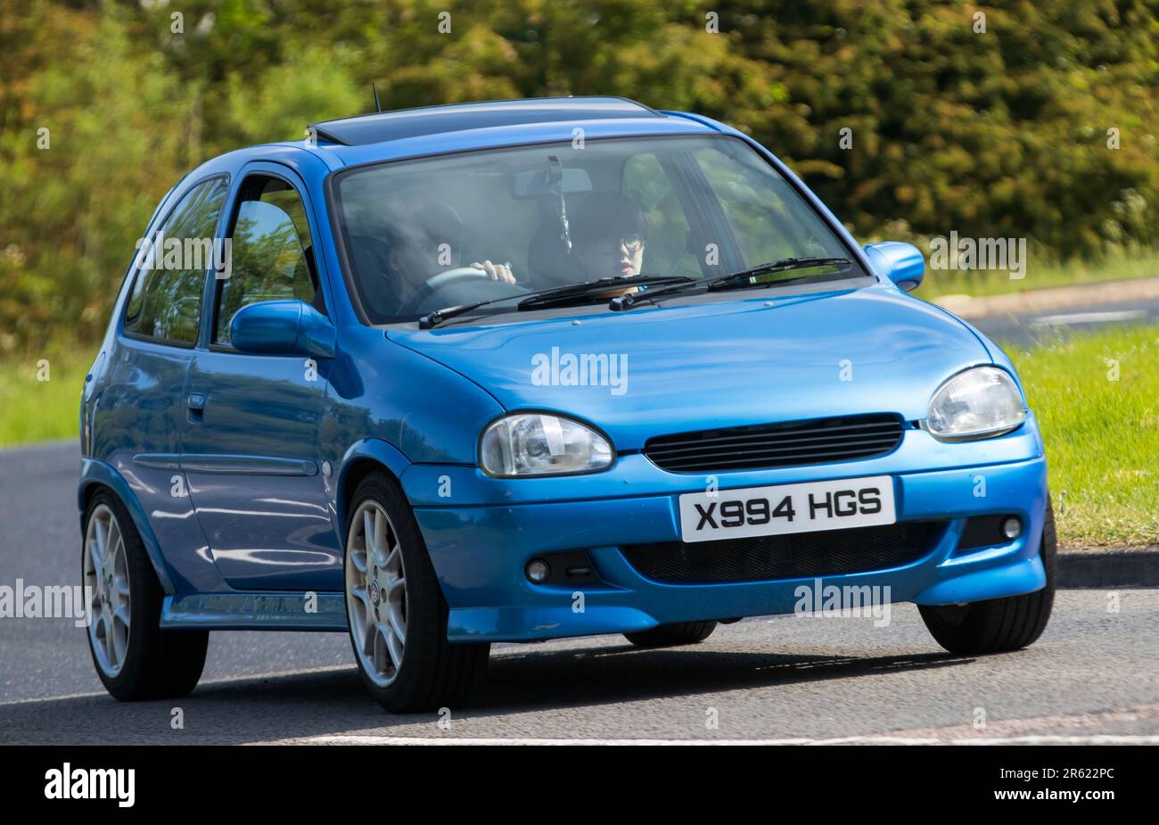 Stony Stratford,UK - June 4th 2023: 2000,blue VAUXHALL CORSA  classic car travelling on an English country road. Stock Photo