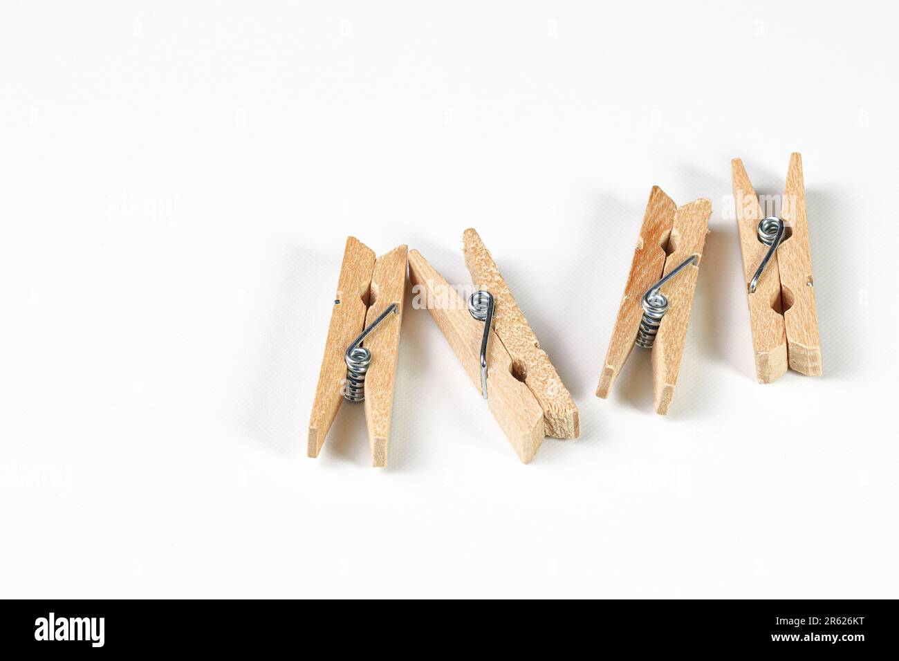 Concept image of tiny clothespins holding different color notes on  clothesline. Isolated on white background Stock Photo - Alamy