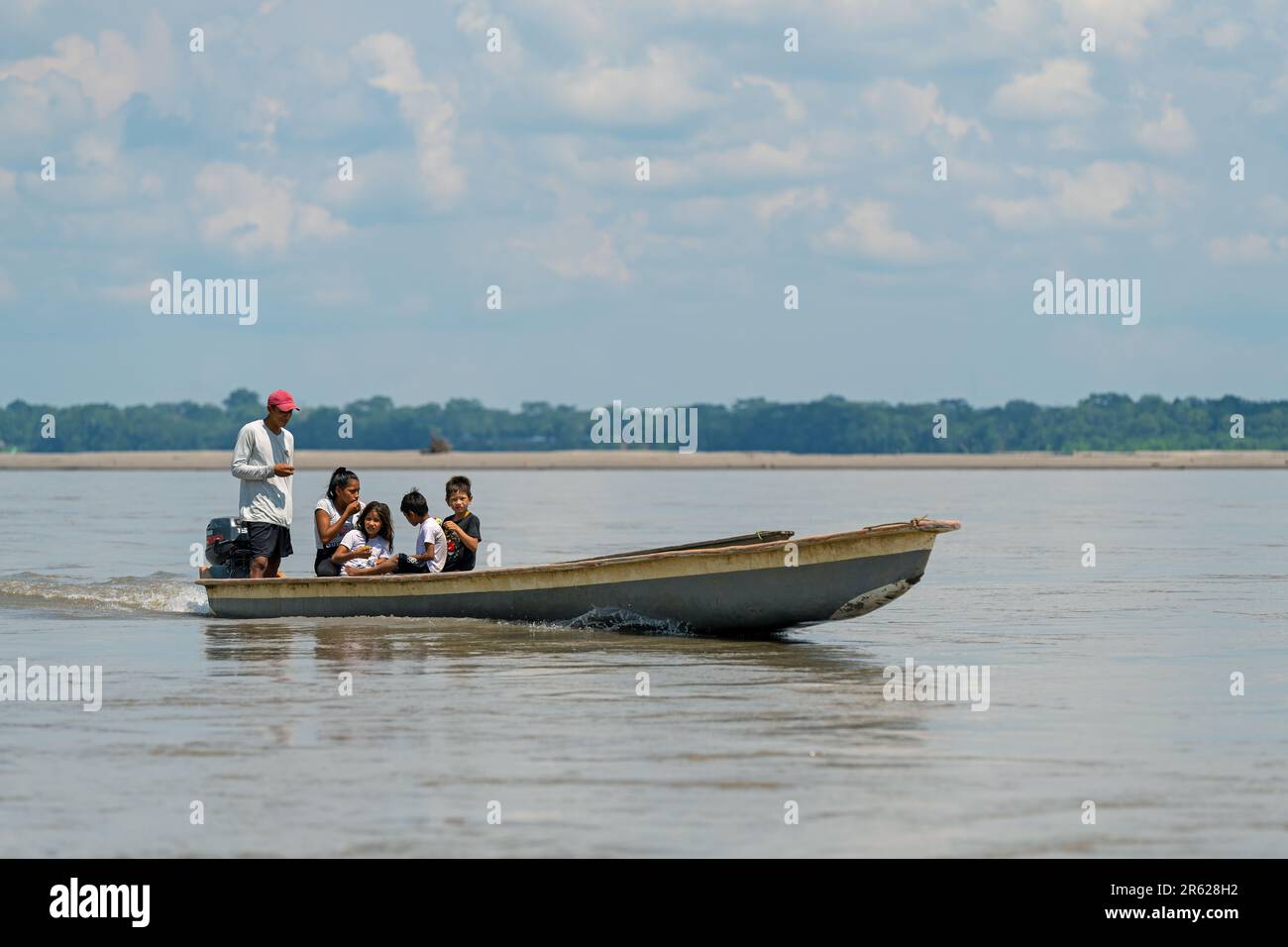 People on motorized canoe transport, Napo River, Yasuni national park, Amazon rainforest, Ecuador. Stock Photo