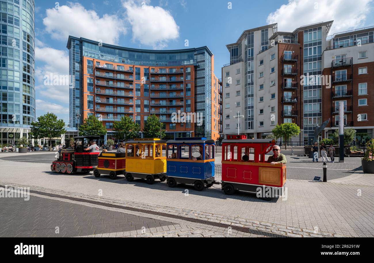 Gunwharf Quays in Portsmouth, Hampshire, England, UK, on a busy Saturday afternoon in June with families and kids having a mini train ride Stock Photo