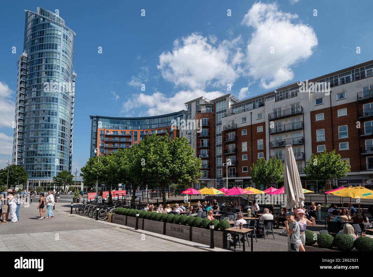Gunwharf Quays in Portsmouth, Hampshire, England, UK, on a busy Saturday afternoon in June with people relaxing and enjoying the outdoor cafes Stock Photo