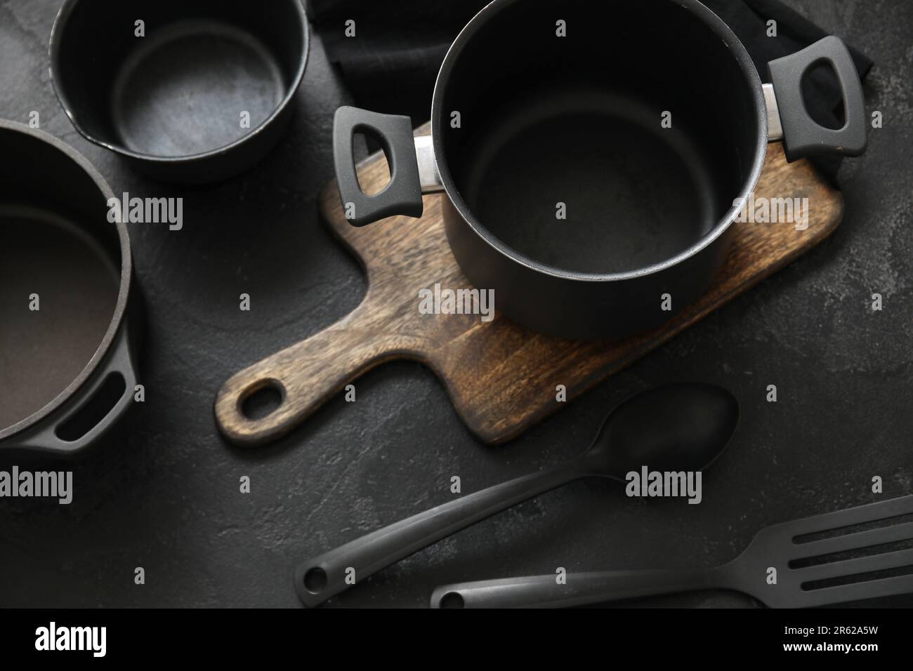Cooking pots and kitchen utensils on dark background Stock Photo Alamy