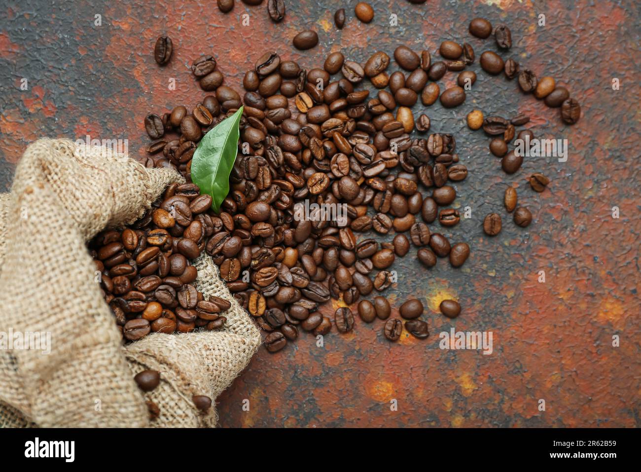 Sack bag with coffee beans on grunge background Stock Photo