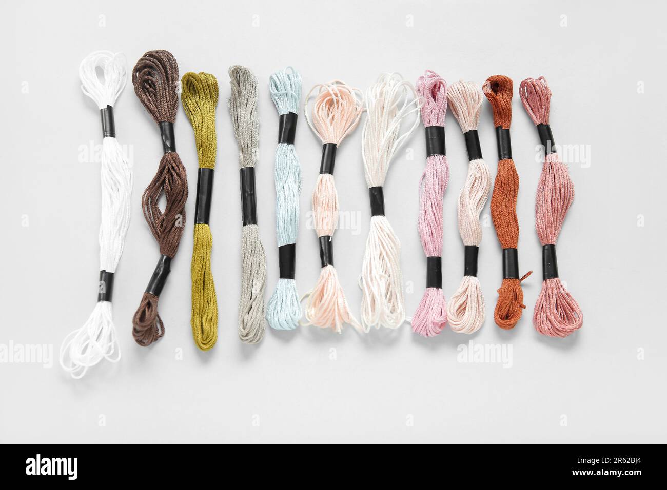 Different colorful mouline threads on white background Stock Photo - Alamy