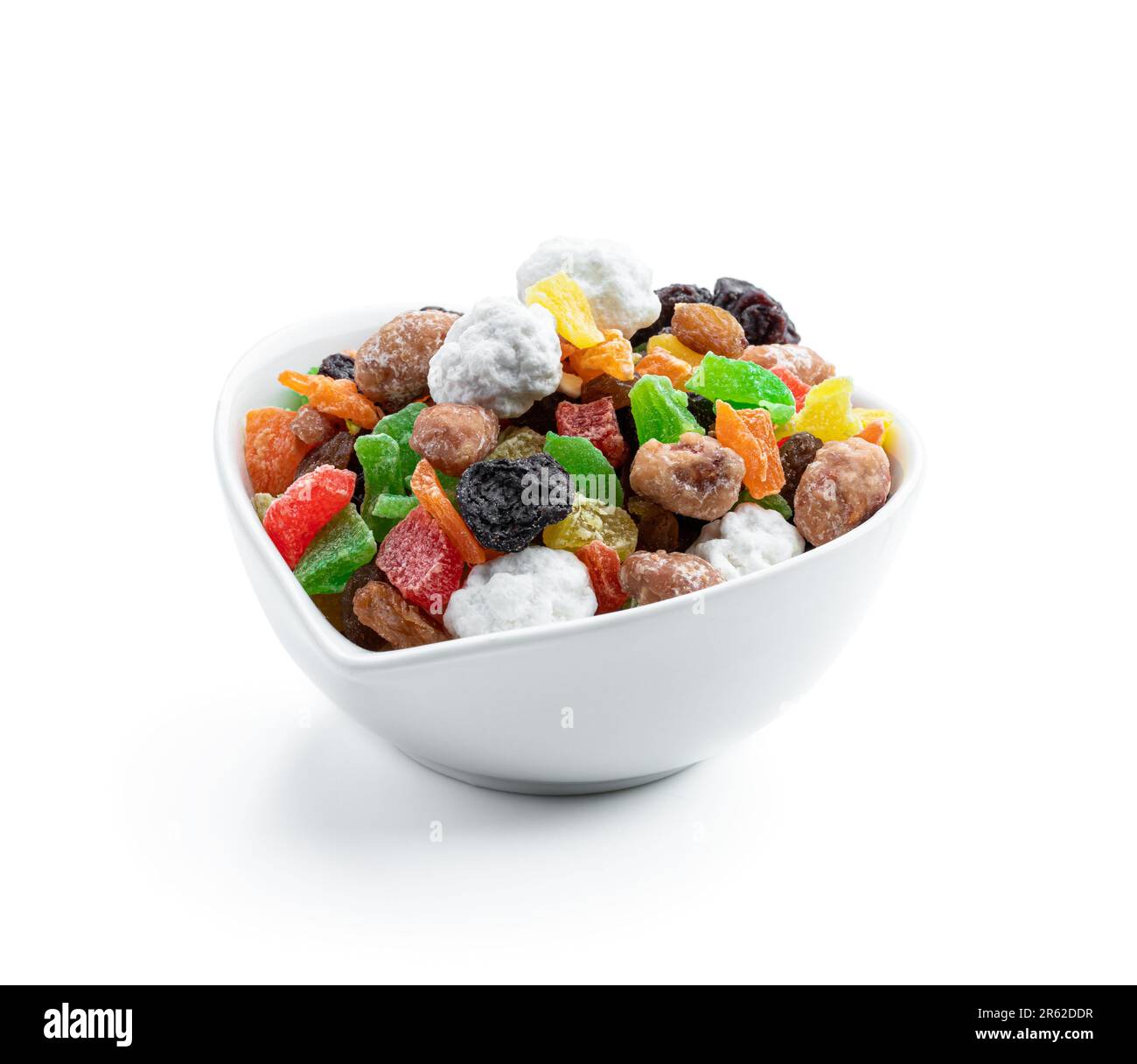 Sugar coated nuts and candied fruit in white plate isolated on white