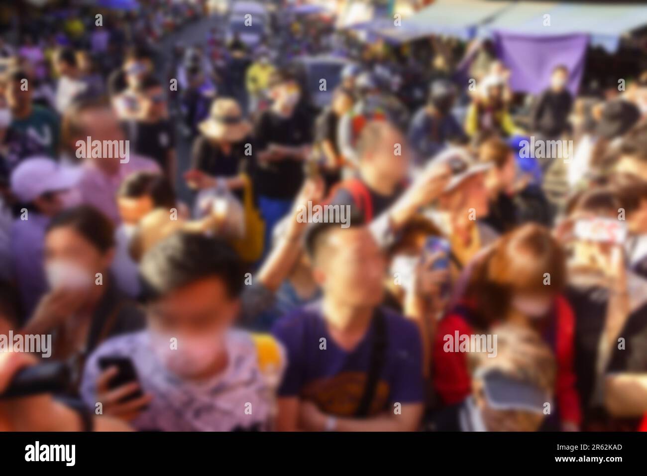A crowd of people in the conditions of coronavirus. Non-compliance with personal infectious safety measures in most cases. Southeast Asia. Blurred unr Stock Photo