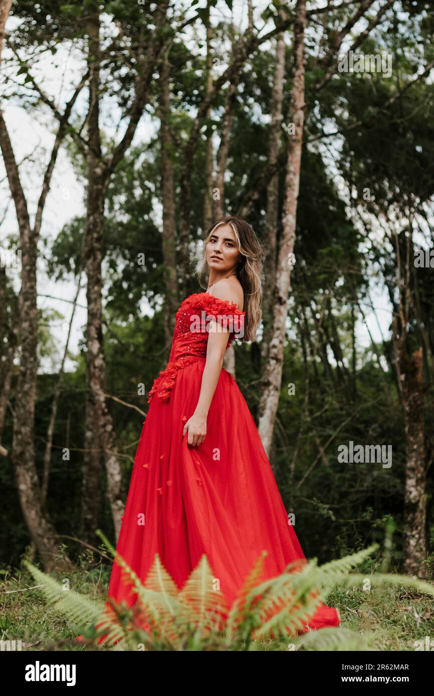 Woman in red dress jumping hi-res stock photography and images - Alamy