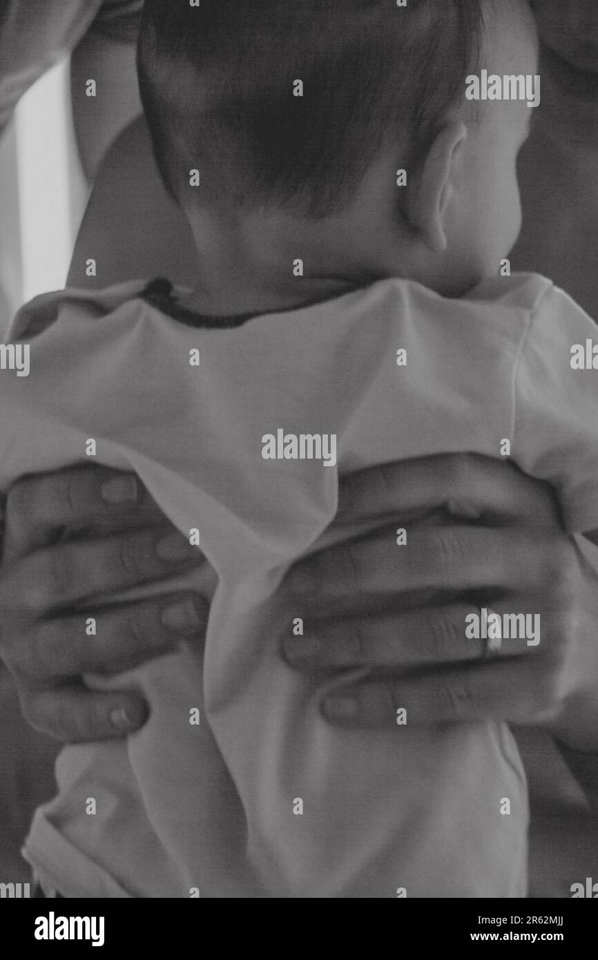 A loving mother holding her newborn child close to her chest in a warm