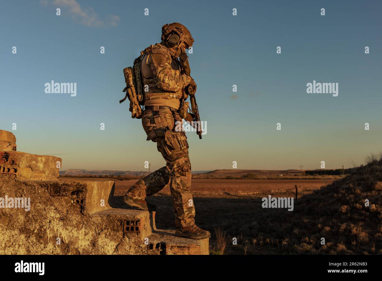 A man wearing a military uniform with a rifle Stock Photo - Alamy