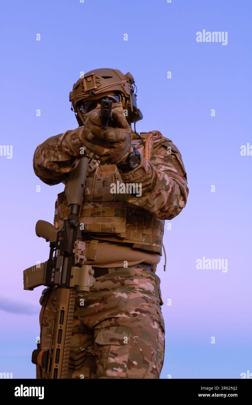Modern Rifles Uniform A man wearing a military uniform with a rifle Stock Photo - Alamy