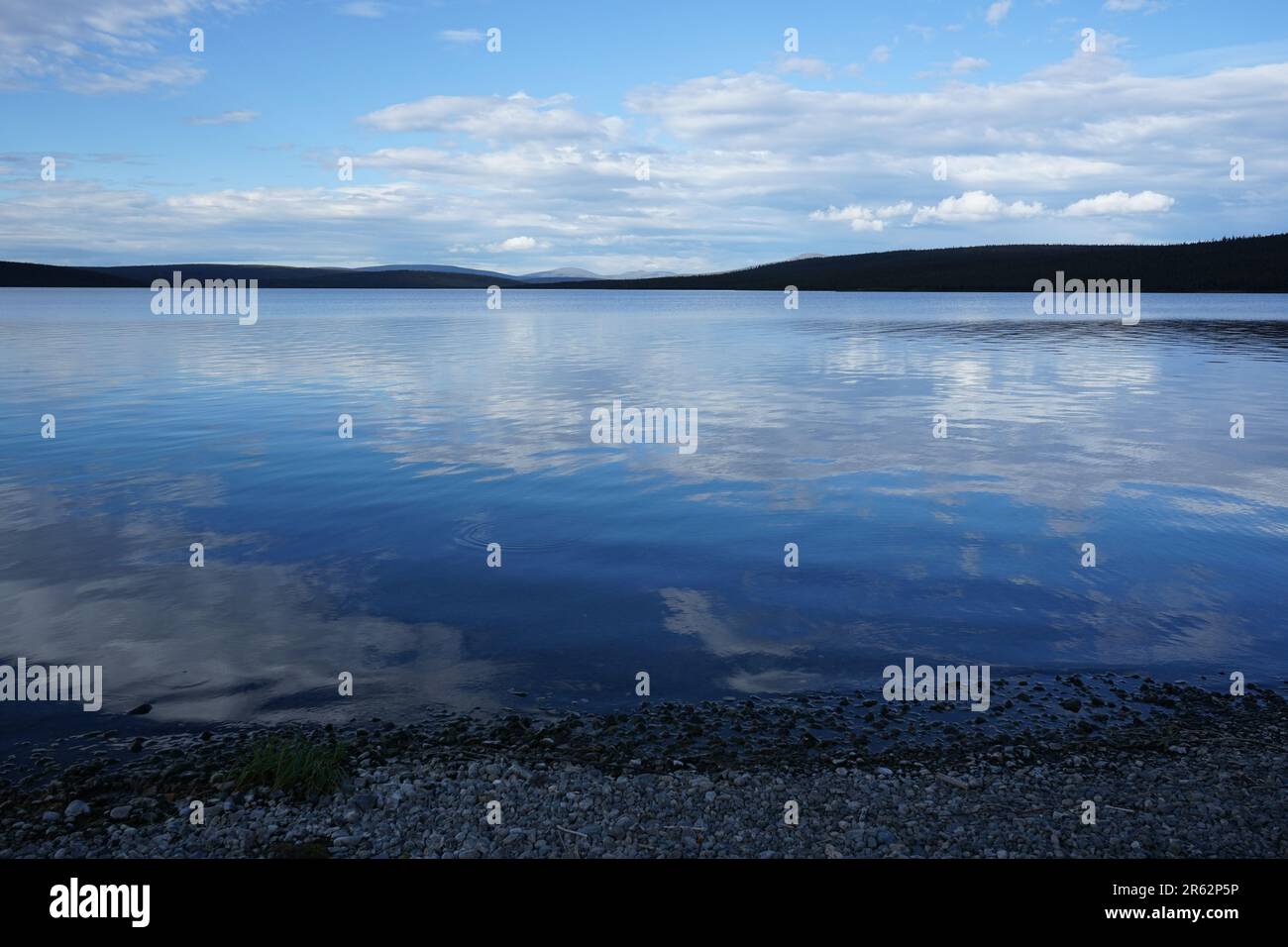 A serene lake view with clear, cold blue waters and skies, embracing