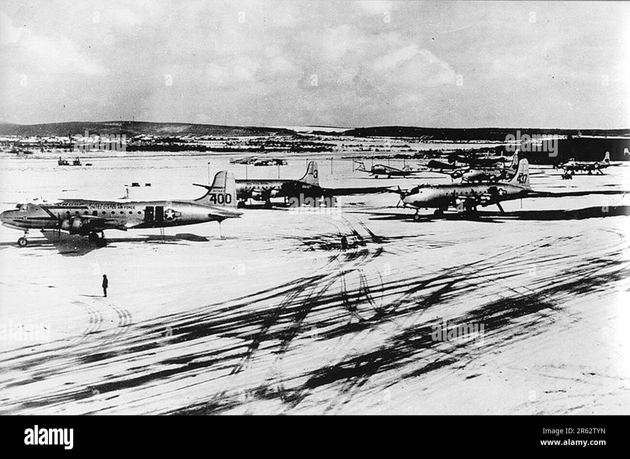 C-54 cargo planes at Wiesbaden Air Base during the Berlin Airlift in March 1949. In response escalating tensions and to the establishment of.a new West German currency, the Soviets cut off all land communications to West Berlin and stopped sending food there. TheAllied response was an eleven month campaign to supply W Berlin with the 5000 tons per day of food and fuel it needed. A plane landed every three minutes day and night and the operation was so succesful that the Soviets had to back down and reopen the roads, railways and canals. Stock Photo