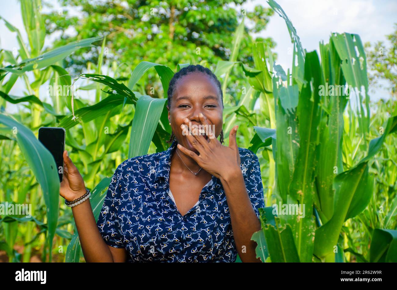 female african farmer using her phone Stock Photo
