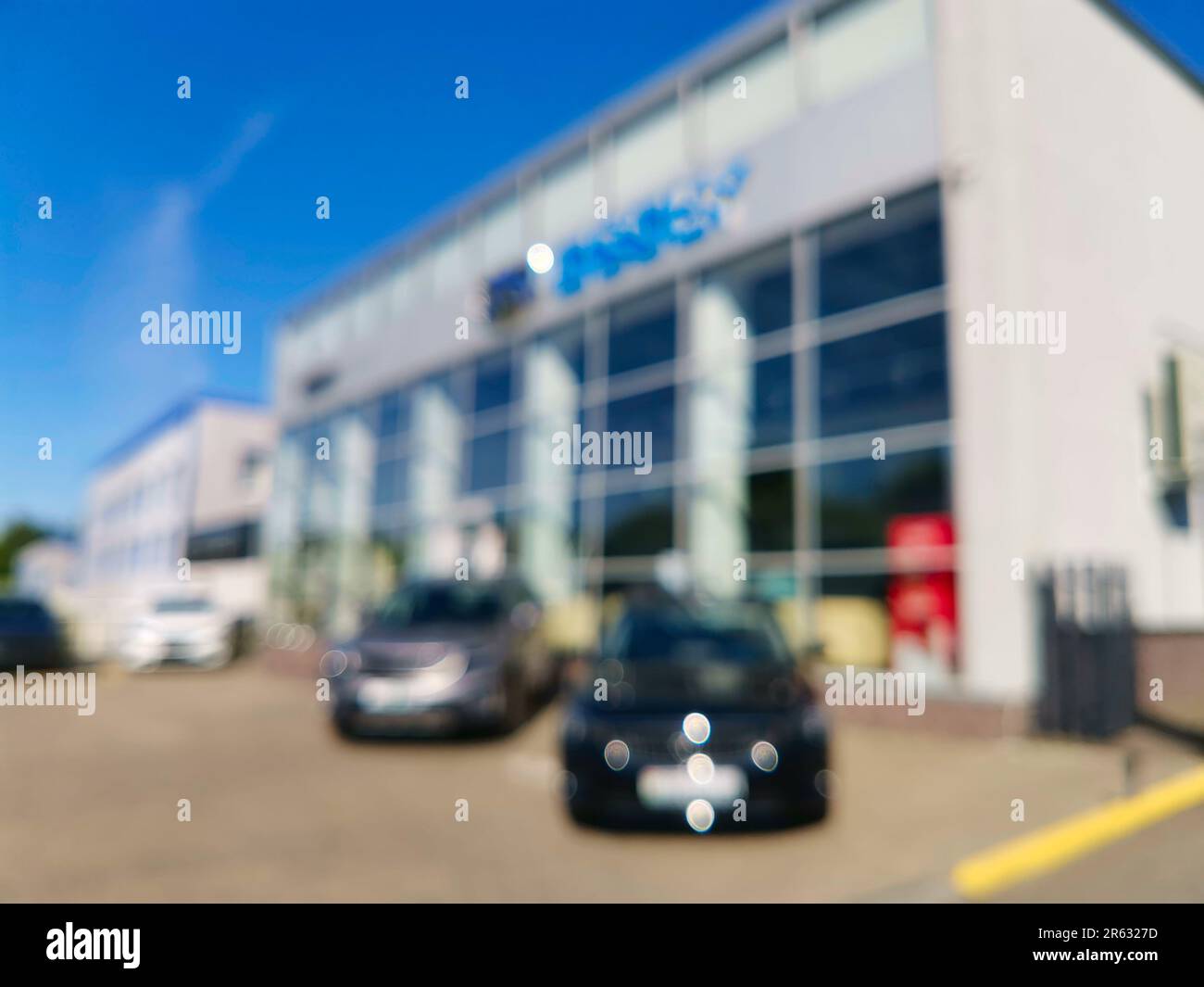 Abstract blurred outside of car dealership. Cars for a test drive