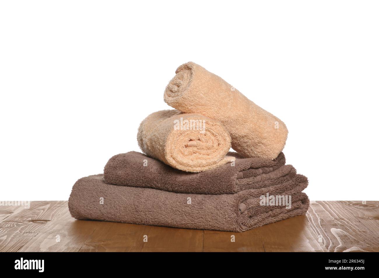 https://c8.alamy.com/comp/2R6345J/soft-colorful-terry-towels-on-wooden-table-against-white-background-2R6345J.jpg