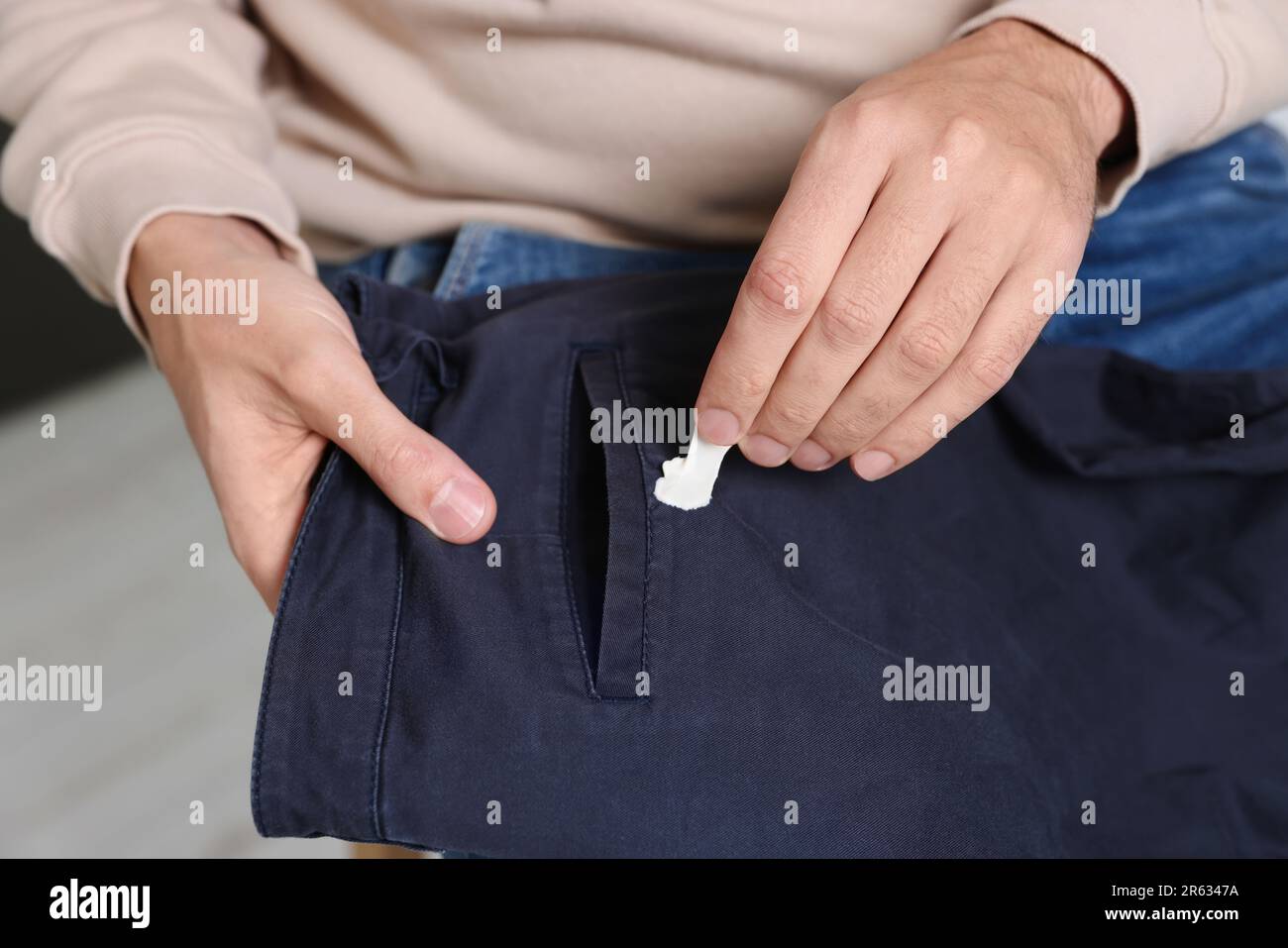 Man removing chewing gum from black jeans, closeup Stock Photo Alamy