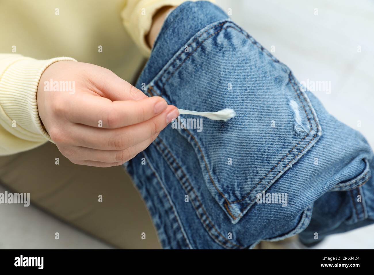 Woman removing chewing gum from jeans, closeup Stock Photo Alamy