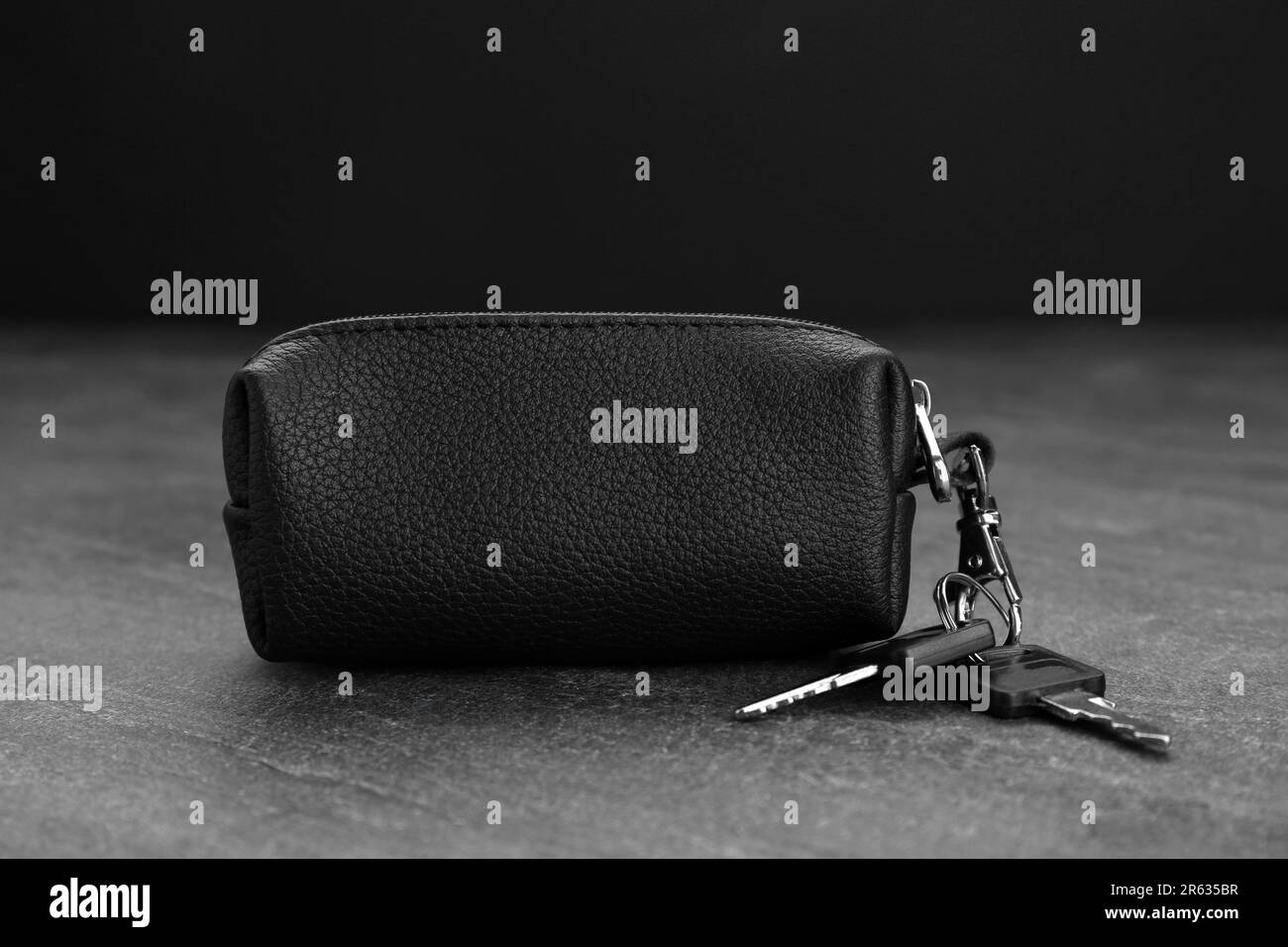Leather case with keys on grey table, closeup Stock Photo