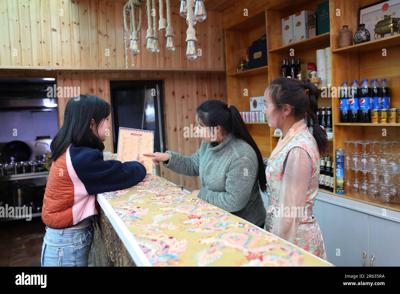 GANNAN, CHINA - JUNE 6, 2023 - Tourists consult price lists in Gannan Tibetan Autonomous Prefecture, Gansu province, China, June 6, 2023. Gaxiu Villag Stock Photo