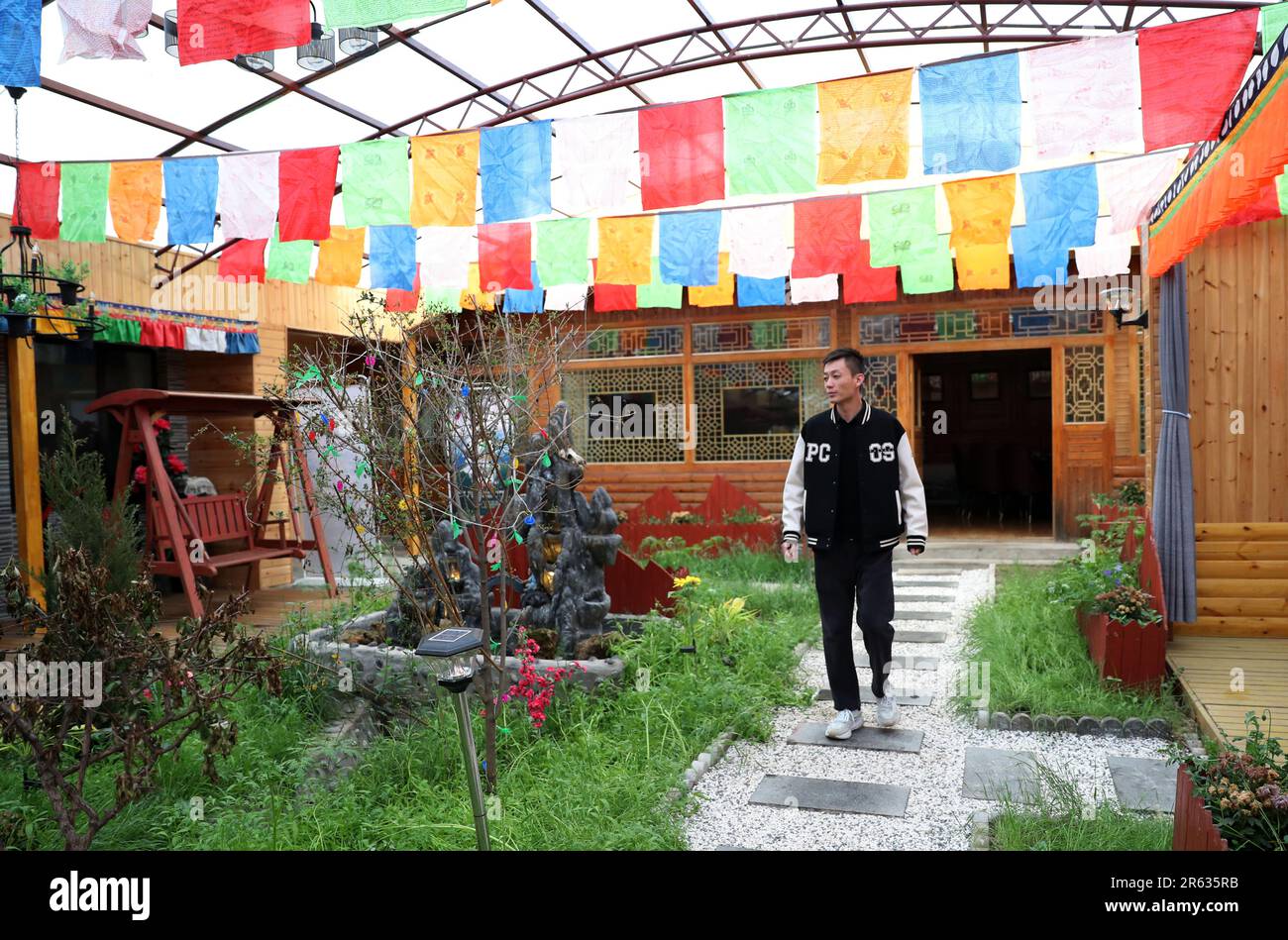GANNAN, CHINA - JUNE 6, 2023 - A tourist plays at a farm in Gannan Tibetan Autonomous Prefecture, Gansu province, China, June 6, 2023. Gaxiu Village, Stock Photo