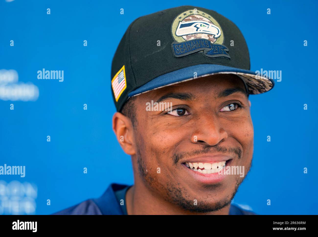 Wide receiver Tyler Lockett of the Seattle Seahawks smiles between