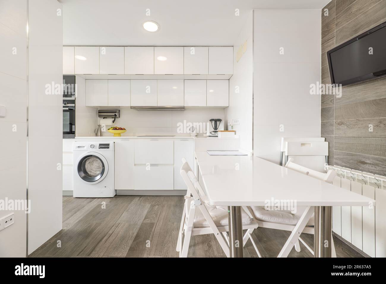 Modern kitchen with glossy white wooden and matching dining