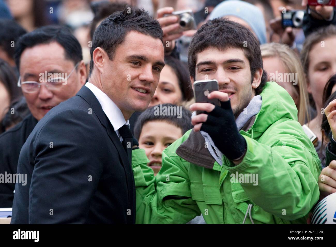 Dan Carter poses for his photograph with a supporter at the official welcome for the New Zealand Rugby World Cup Team, Aotea Square, Auckland, New Zealand, Saturday, September 03, 2011. Stock Photo