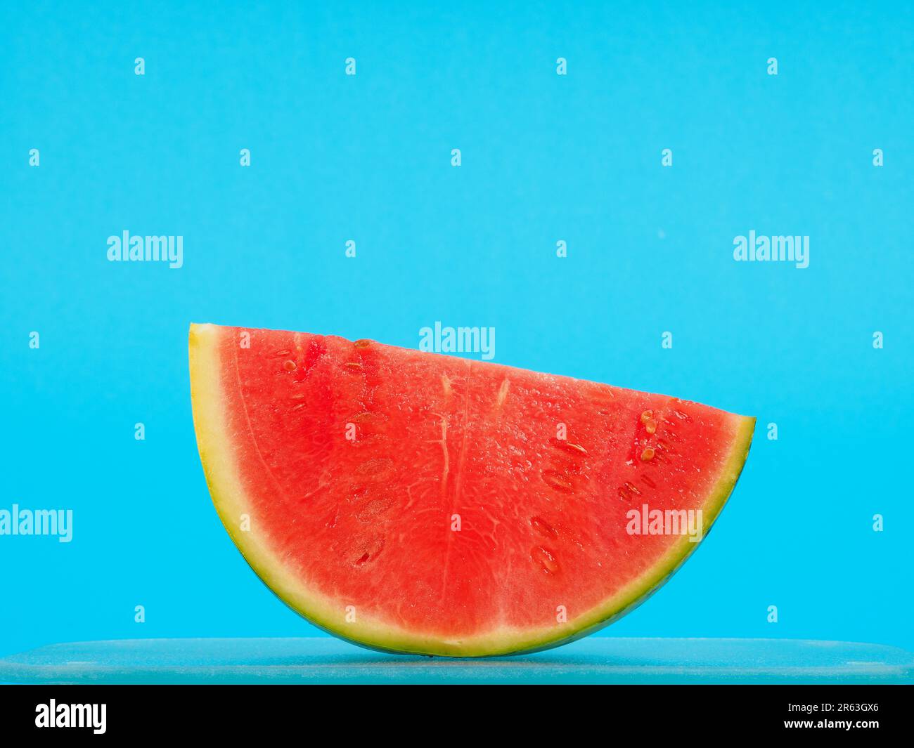 Slice of a watermelon on a blue background, summer food or healthy ...