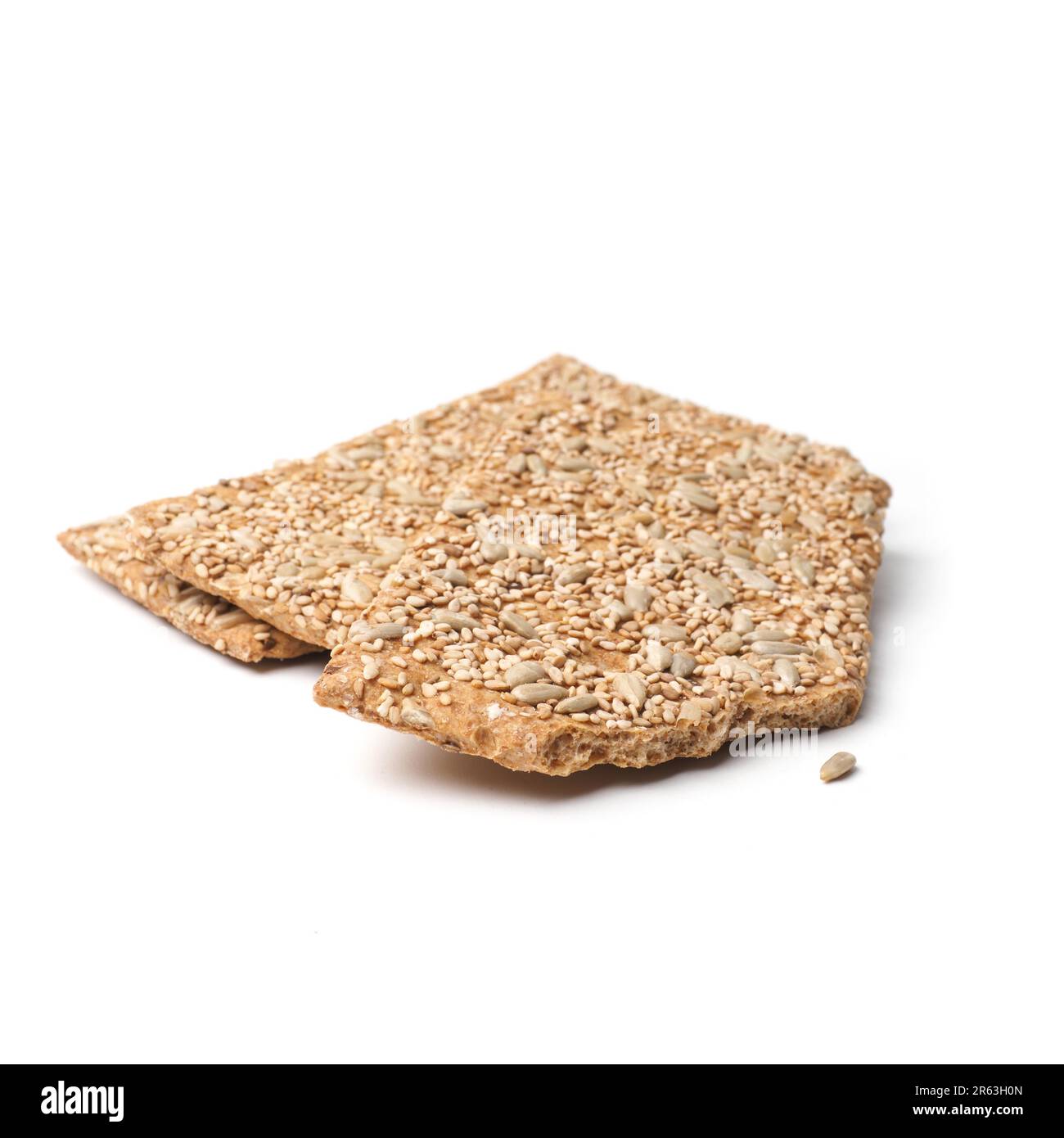 Wholemeal crisp bread with sunflower seeds on a white studio background ...