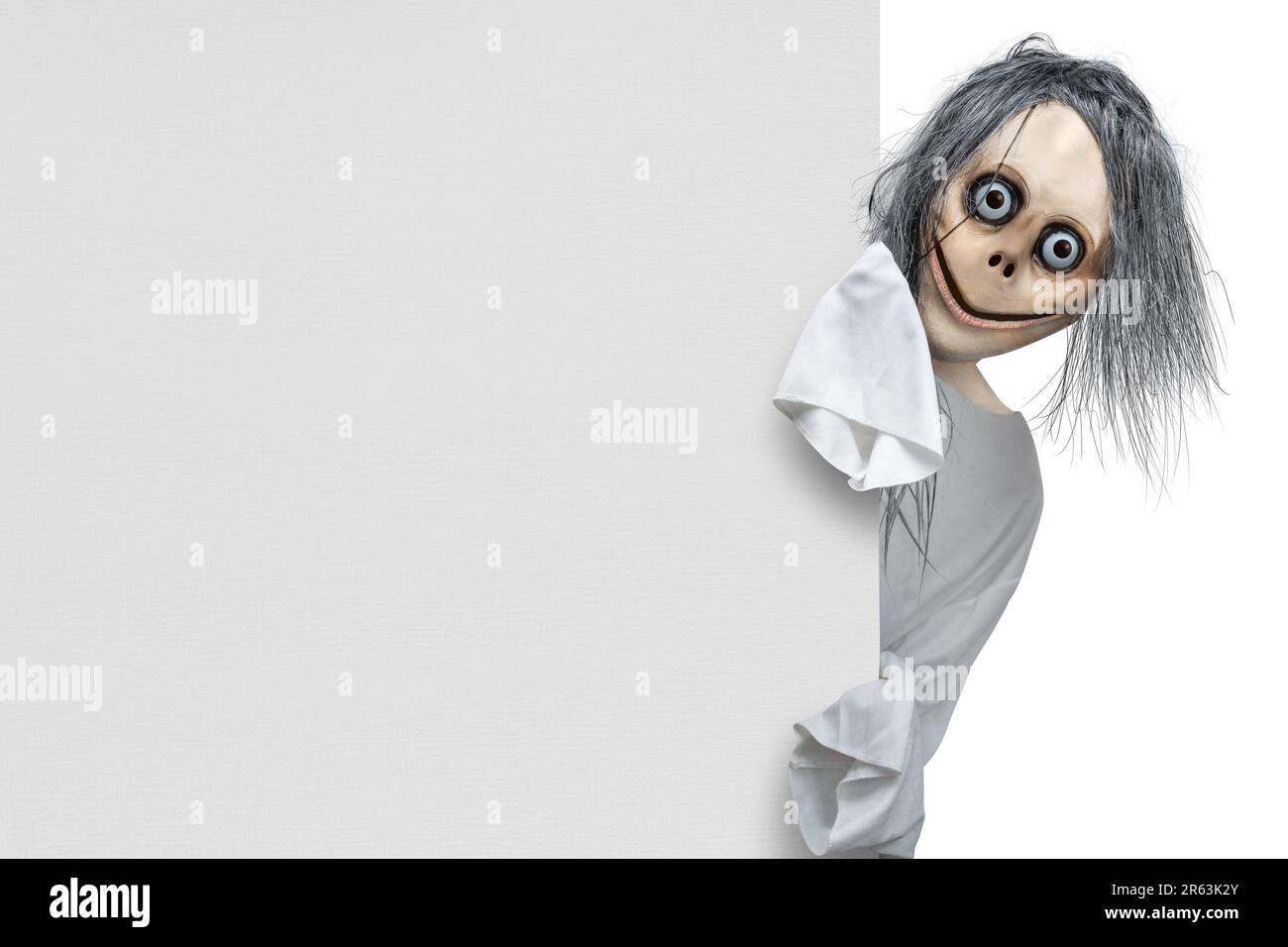Scary Momo standing behind the wall on white background. Scary face for  Halloween decoration Stock Photo - Alamy