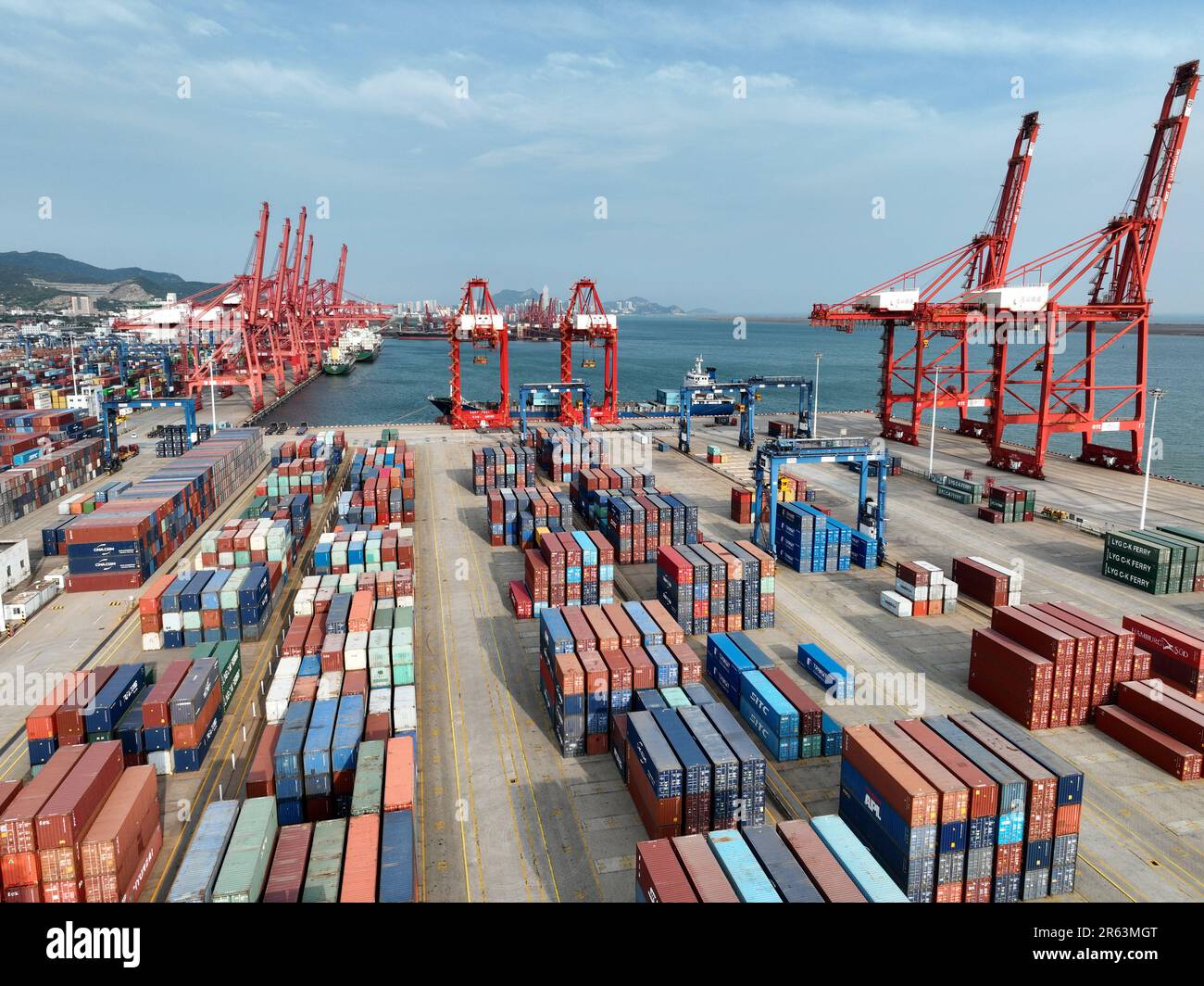 LIANYUNGANG, CHINA - JUNE 7, 2023 - Cargo ships dock at a berth to load ...
