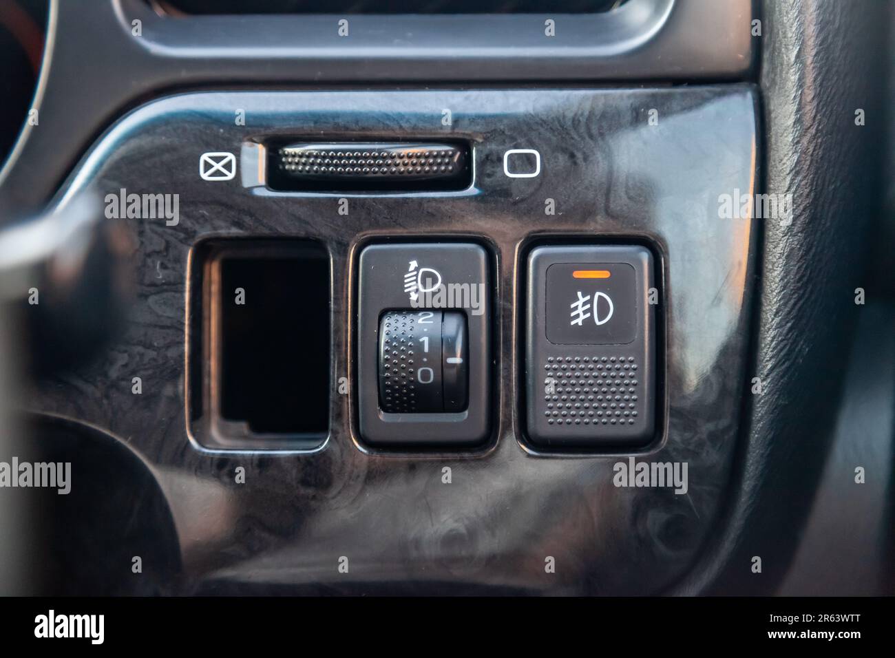 The dashboard of the car's interior is black with a dipped headlamp
