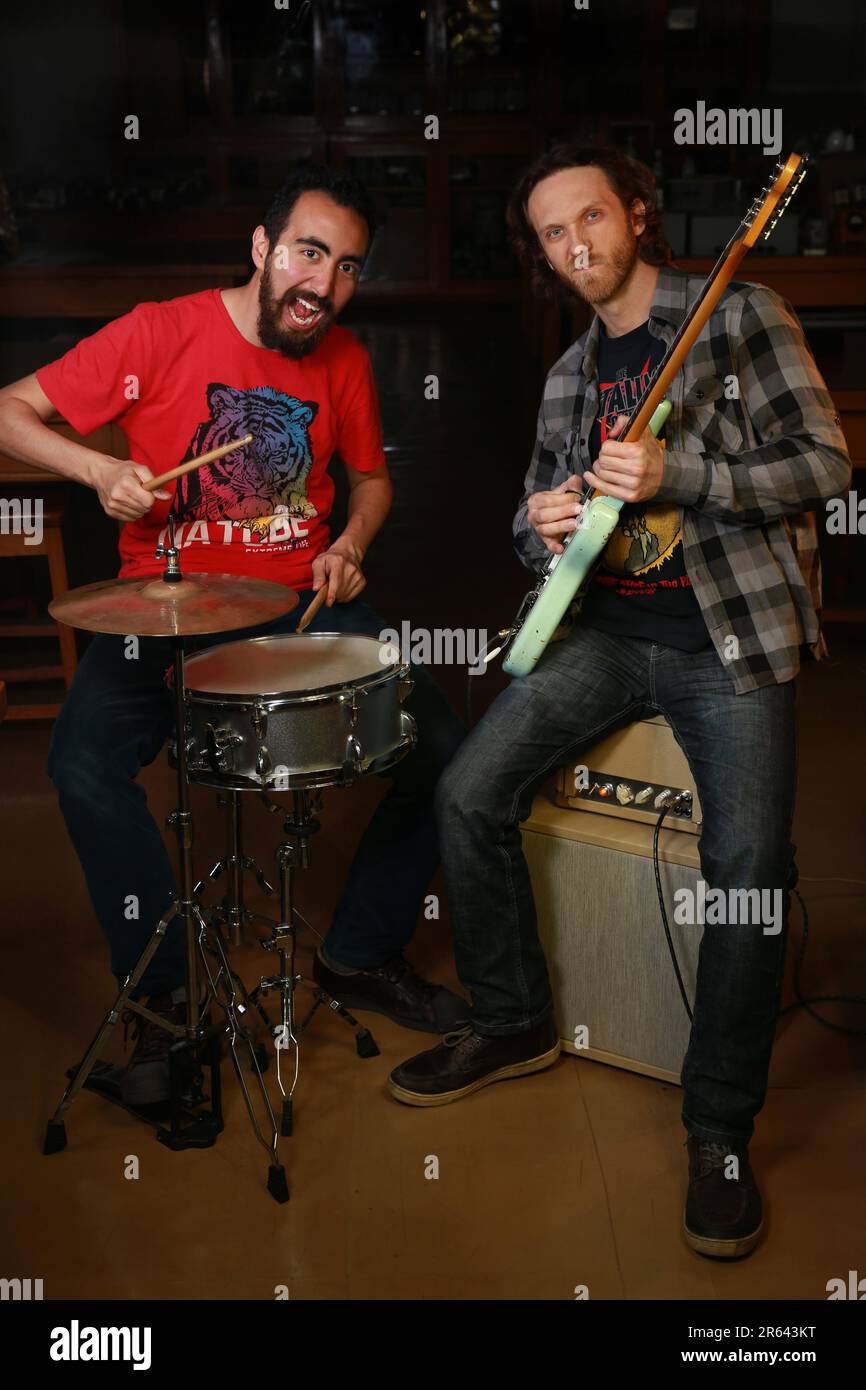 Bearded guitarist and drummer playing music Stock Photo