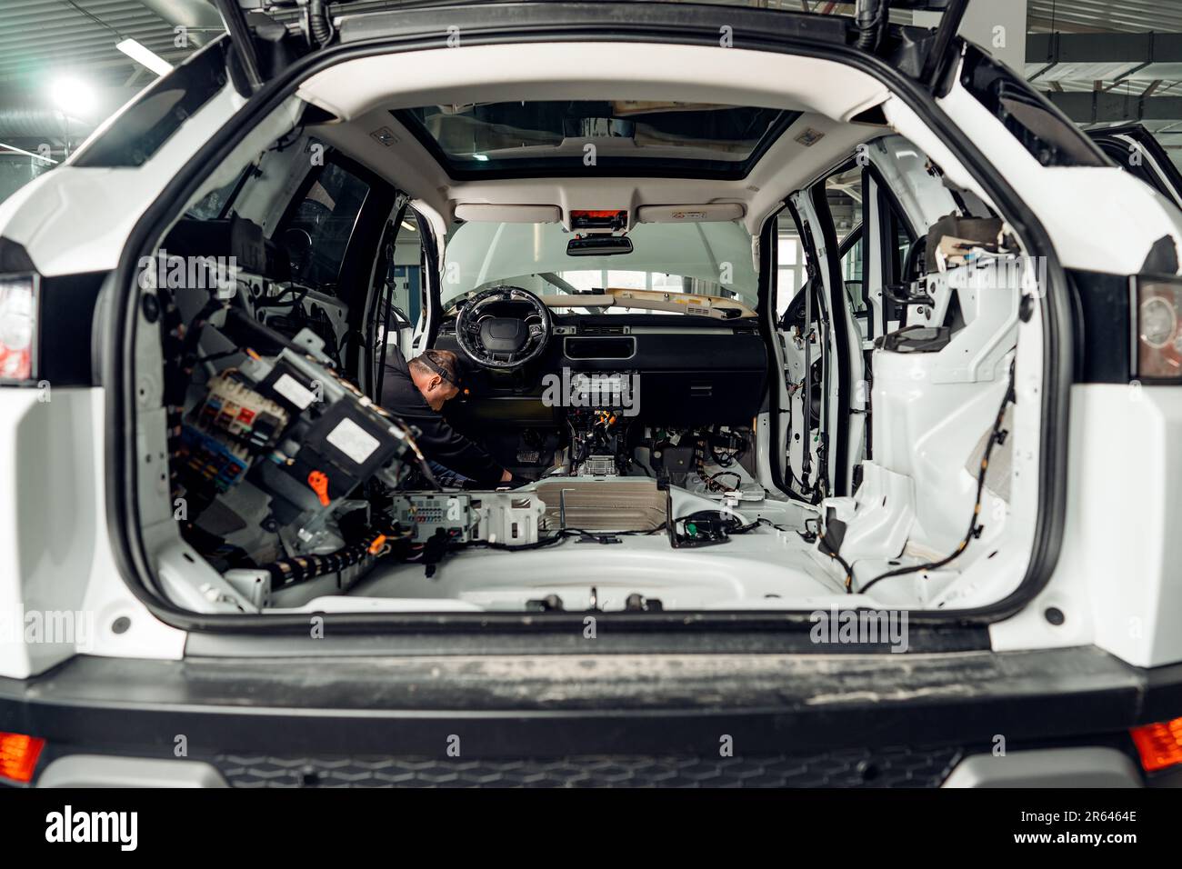Car service worker installing noise insulation soundproofing in the car