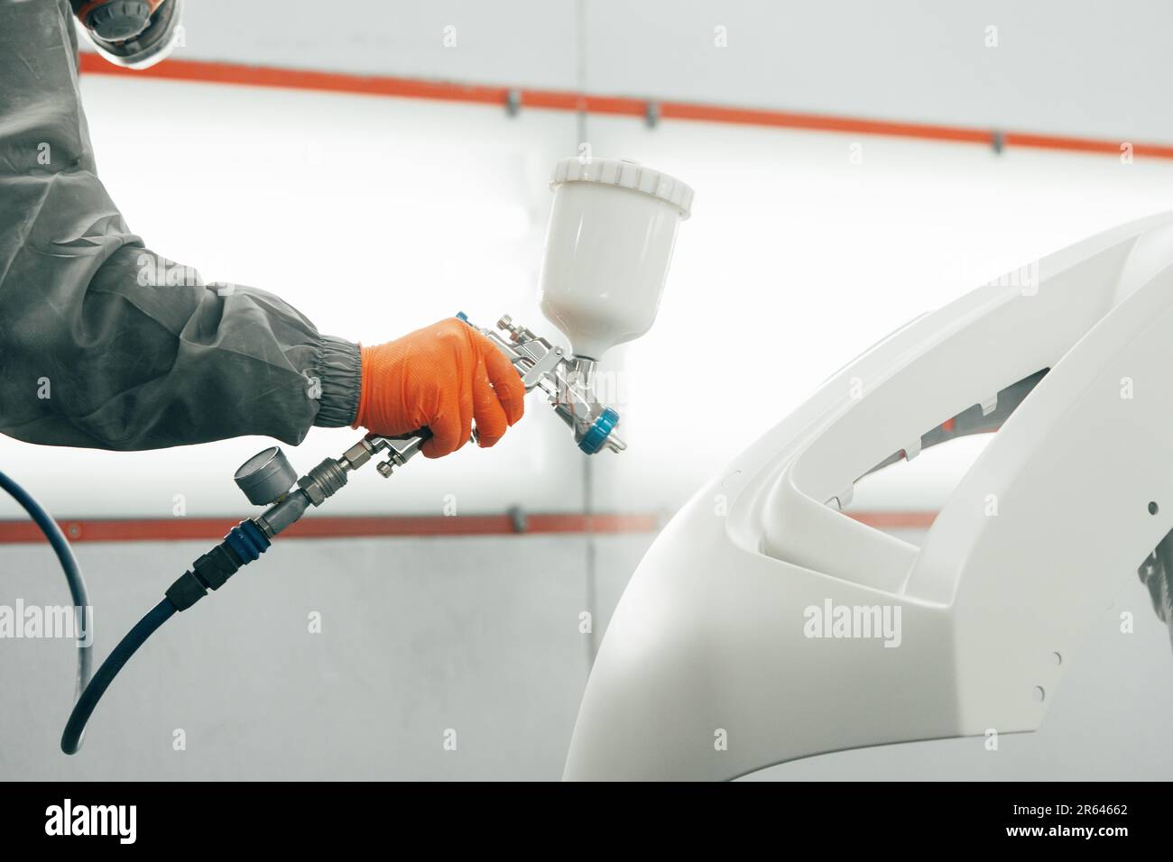 Airbrush paint gun in paint in car service station Stock Photo Alamy