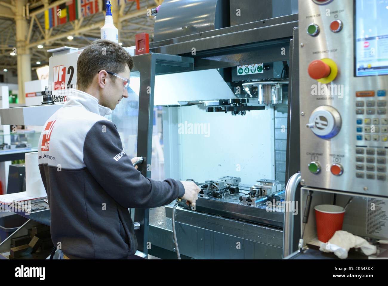 Man worker working with a CNC milling machine, stand. Industry ...