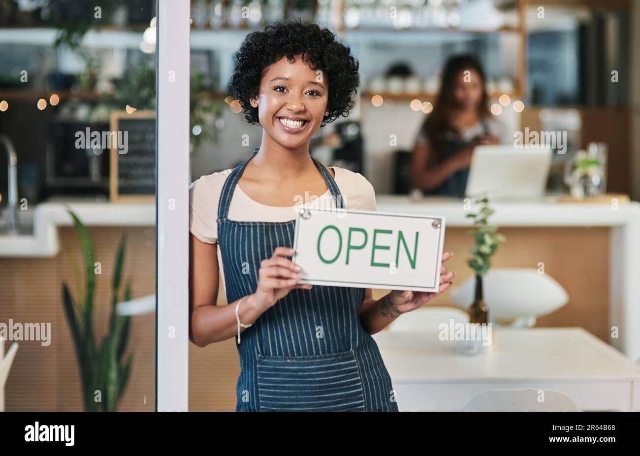 Happy woman, open sign and portrait at cafe of waitress or small business owner for morning or ready to serve. African female person at restaurant Stock Photo